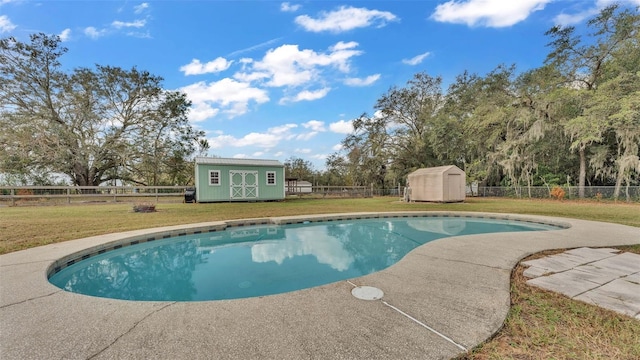 view of pool featuring a storage unit and a yard