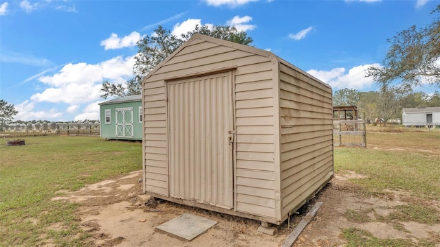 view of outbuilding with a lawn