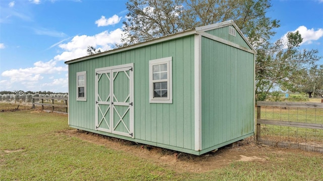 view of outdoor structure with a lawn