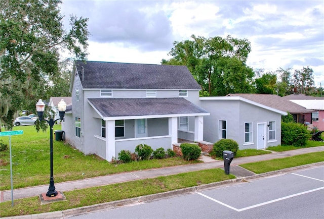 view of front of home featuring a porch and a front lawn