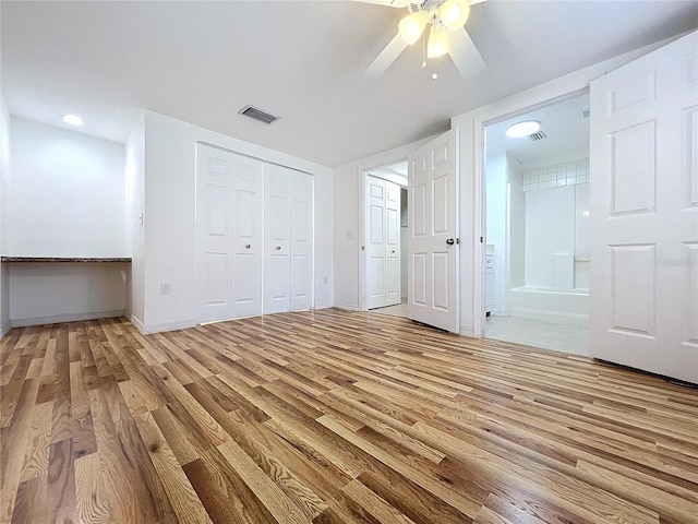 unfurnished bedroom with light hardwood / wood-style flooring, ceiling fan, and ensuite bath