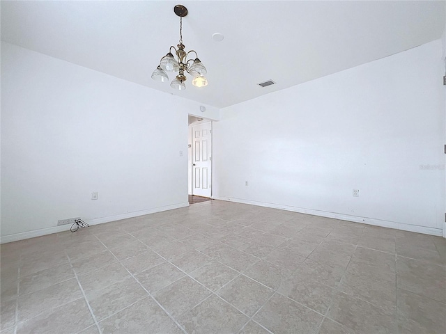 unfurnished room with a chandelier