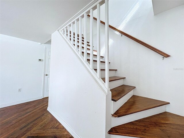 stairway featuring wood-type flooring