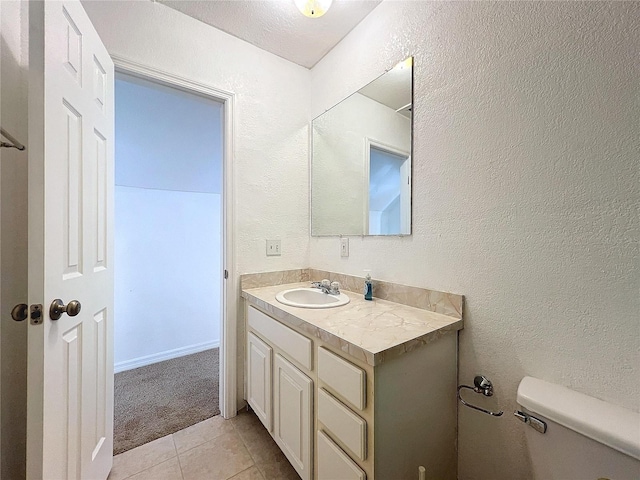 bathroom featuring toilet, vanity, and tile patterned floors