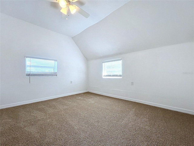 additional living space with ceiling fan, vaulted ceiling, and carpet floors