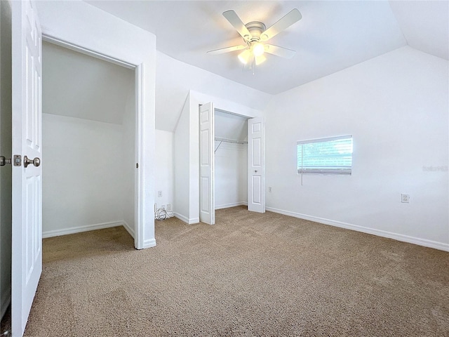 unfurnished bedroom with carpet, ceiling fan, and vaulted ceiling