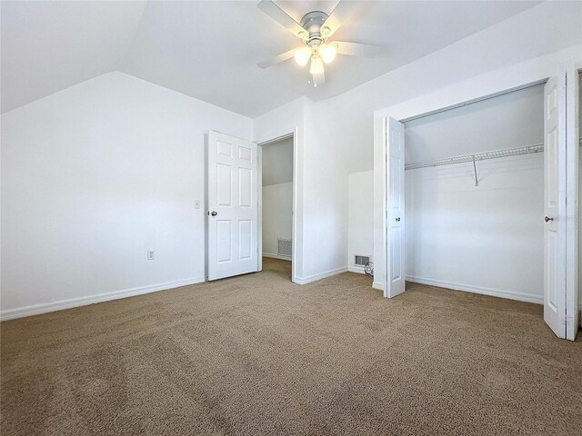 unfurnished bedroom featuring ceiling fan, carpet flooring, a closet, and lofted ceiling