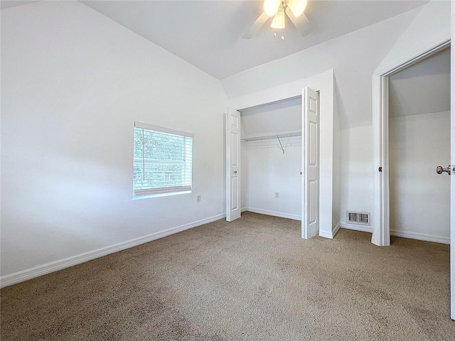 unfurnished bedroom featuring lofted ceiling, ceiling fan, a closet, and carpet floors