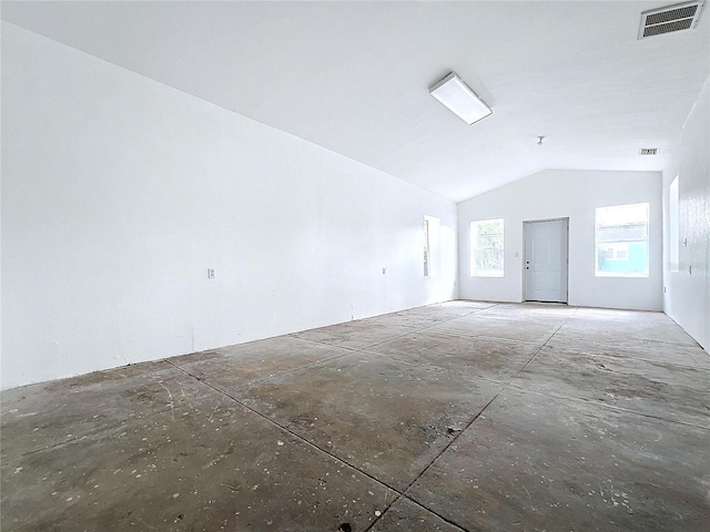 empty room featuring lofted ceiling