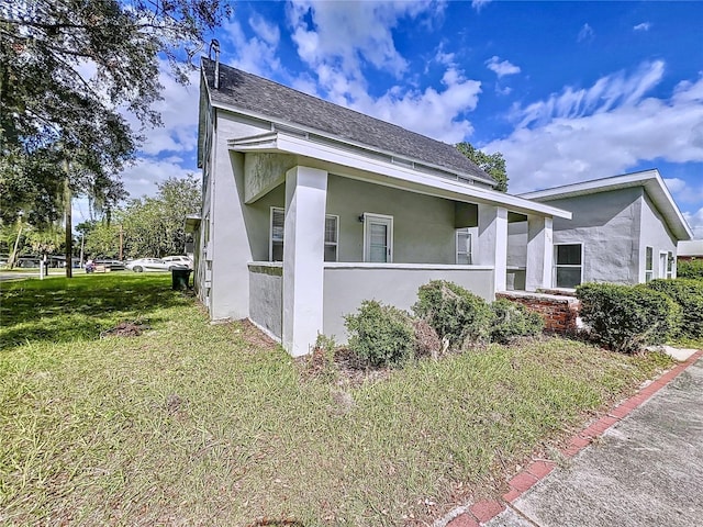 view of side of home with a lawn