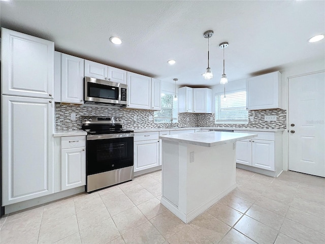 1010 Martin Luther King Jr Blvd, Bartow, FL 33830 - kitchen featuring stainless steel appliances, light countertops, decorative backsplash, white cabinetry, and recessed lighting
