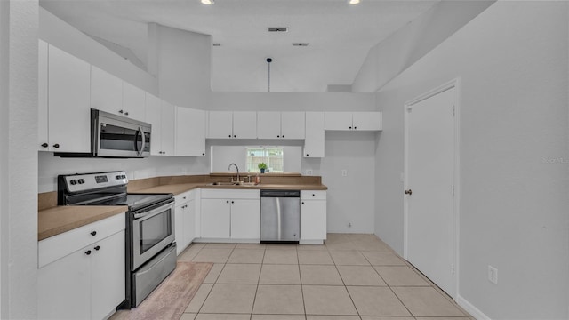 kitchen with white cabinets, stainless steel appliances, and sink