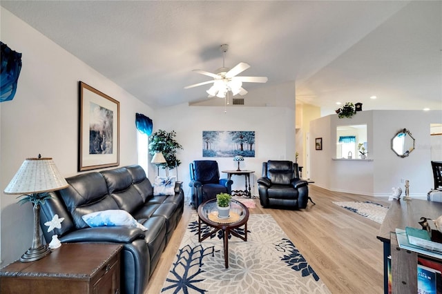 living room featuring ceiling fan, vaulted ceiling, plenty of natural light, and light wood-type flooring