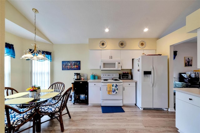 kitchen featuring white appliances, light hardwood / wood-style flooring, decorative light fixtures, and white cabinets