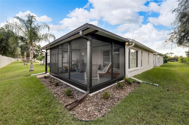 view of property exterior featuring a yard and a sunroom