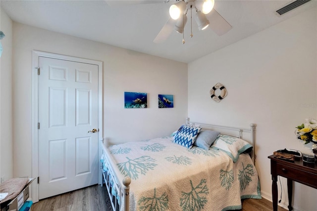 bedroom with ceiling fan and hardwood / wood-style floors