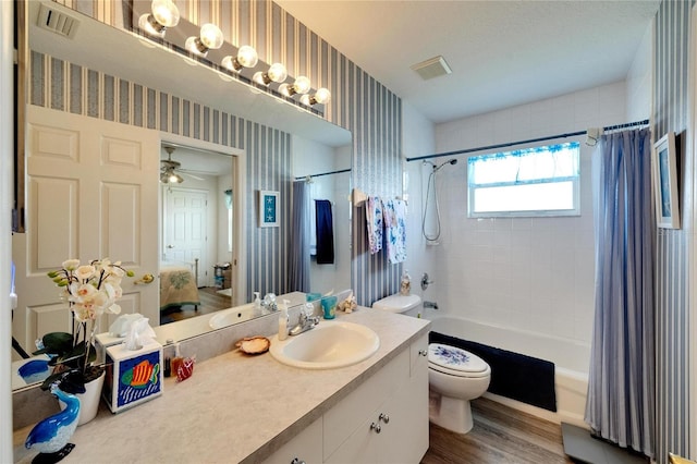 full bathroom featuring vanity, hardwood / wood-style flooring, toilet, and shower / bath combo with shower curtain