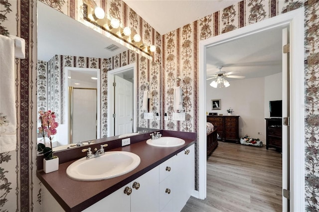 bathroom featuring wood-type flooring, vanity, and ceiling fan