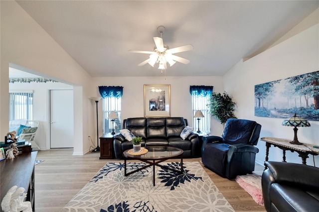 living room featuring ceiling fan, lofted ceiling, and light wood-type flooring