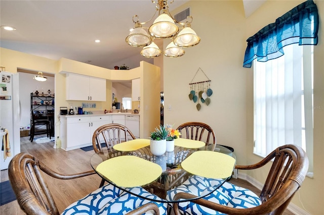 dining room featuring a chandelier and light hardwood / wood-style floors