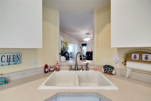 kitchen featuring ceiling fan, lofted ceiling, and sink