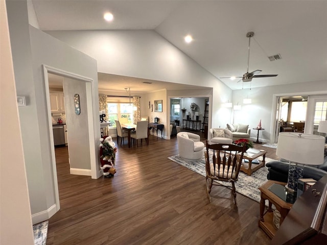 living room featuring high vaulted ceiling, ceiling fan, and dark wood-type flooring