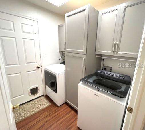 washroom featuring cabinets, hookup for a washing machine, and dark hardwood / wood-style floors