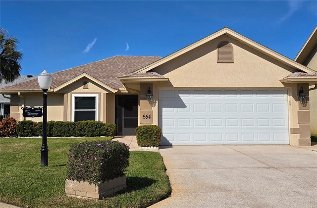 single story home featuring a garage and a front lawn