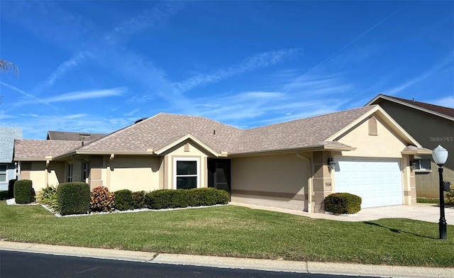 ranch-style house featuring a garage and a front lawn