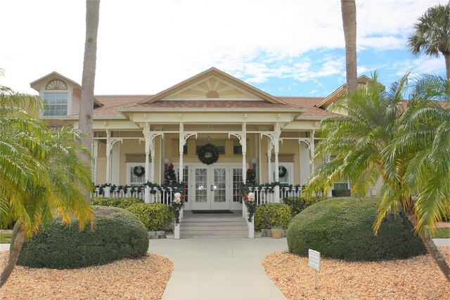 exterior space featuring a porch and french doors