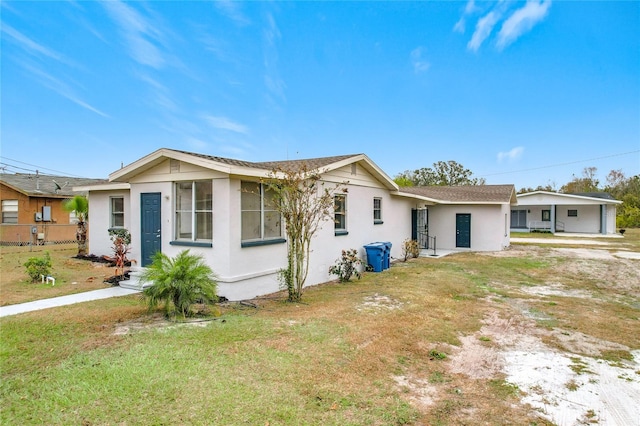 ranch-style home with a front lawn