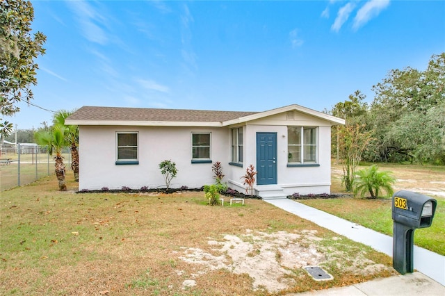 ranch-style house featuring a front lawn