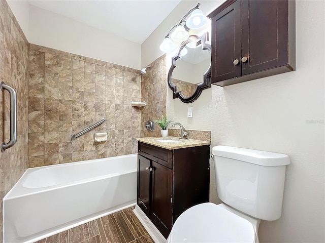 full bathroom featuring toilet, vanity, and tiled shower / bath