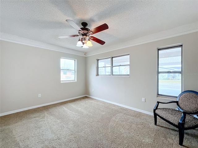 unfurnished room with ceiling fan, crown molding, a textured ceiling, and carpet flooring