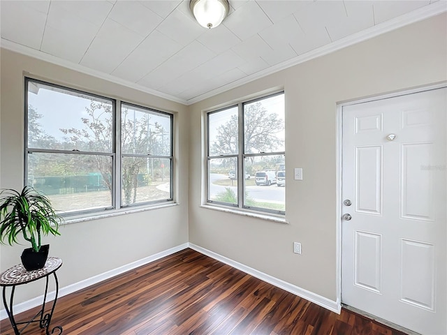 entrance foyer with dark wood-type flooring and ornamental molding