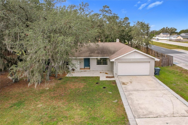 ranch-style home with a front lawn and a garage