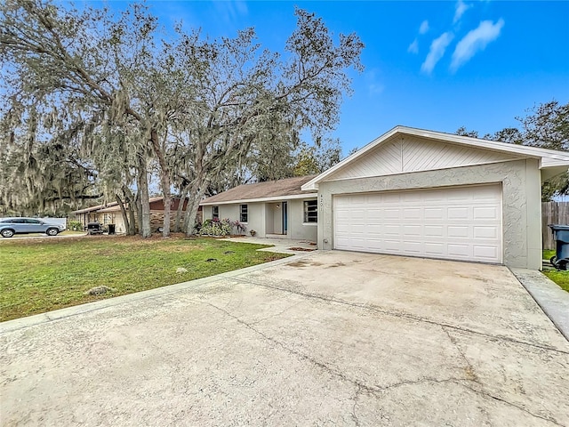 single story home featuring a garage and a front lawn