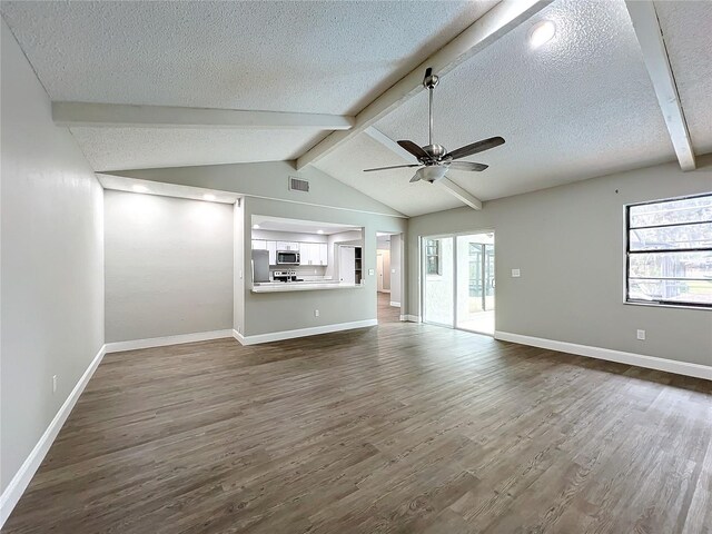 unfurnished living room featuring wood-type flooring, a textured ceiling, lofted ceiling with beams, and ceiling fan