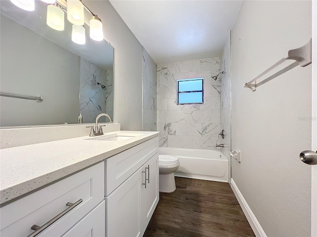 full bathroom featuring wood-type flooring, vanity, toilet, and tiled shower / bath