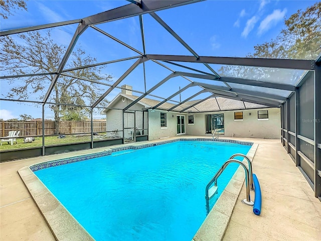 view of swimming pool with a lanai and a patio