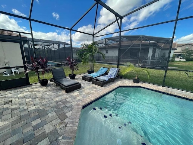 view of swimming pool with a yard, a lanai, and a patio