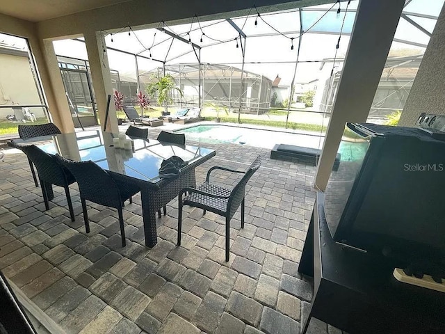 view of patio featuring glass enclosure