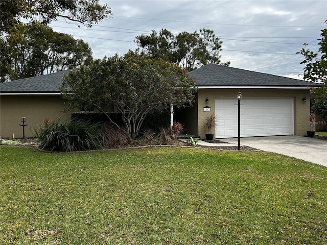 view of front of home with a front lawn and a garage