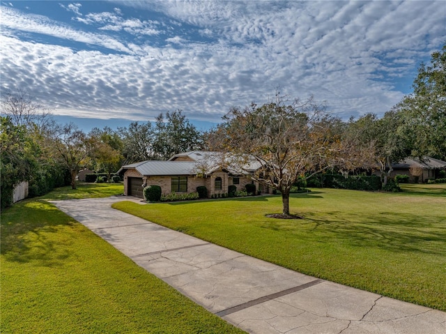 ranch-style house featuring a front yard and a garage