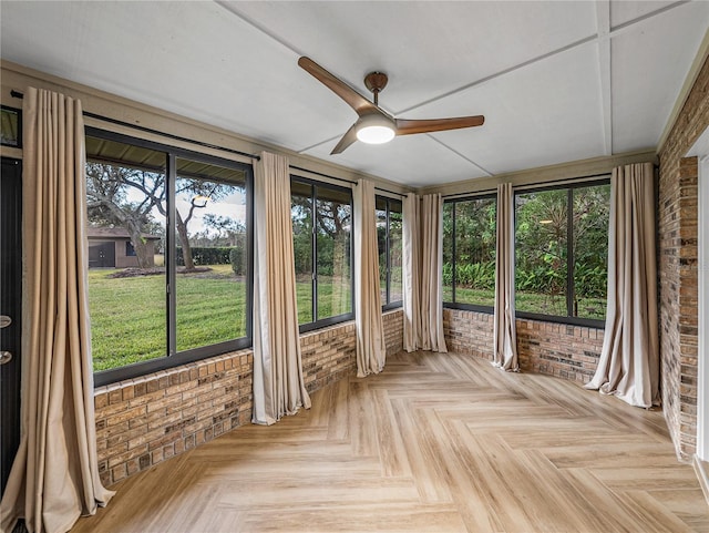 unfurnished sunroom with ceiling fan