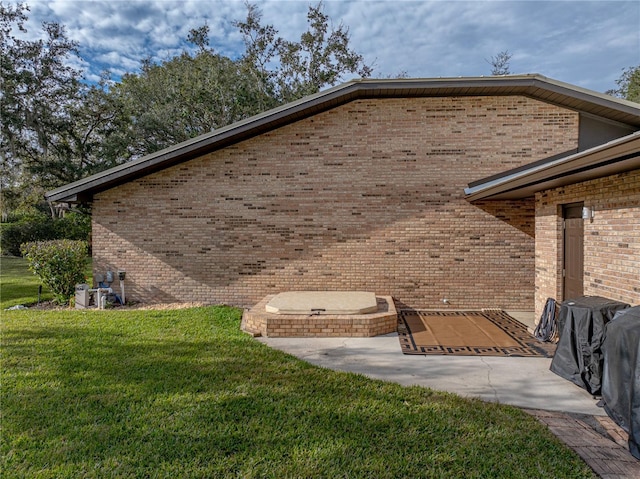 view of side of property with a lawn