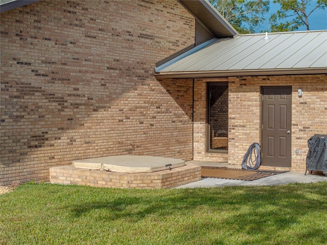 doorway to property featuring a yard