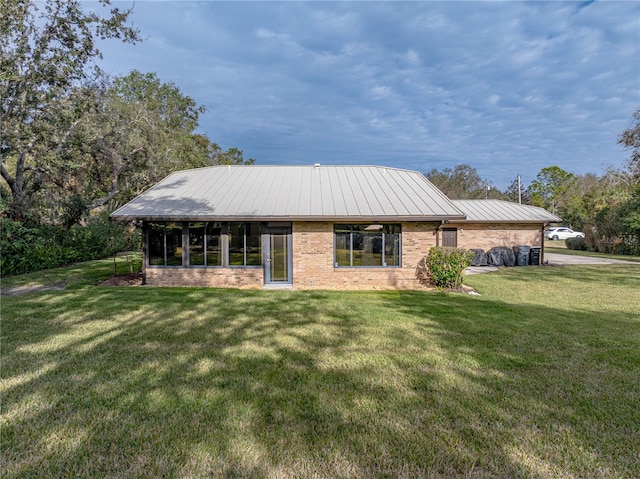 back of house featuring a yard