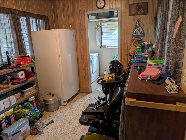 kitchen with white refrigerator, washer / dryer, and wooden walls