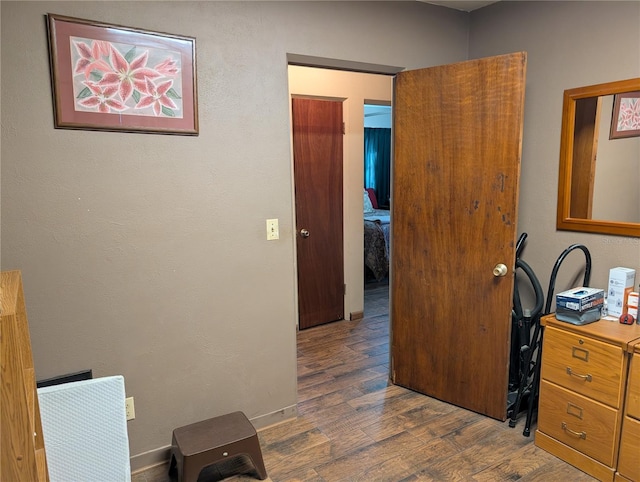 hallway with dark hardwood / wood-style floors